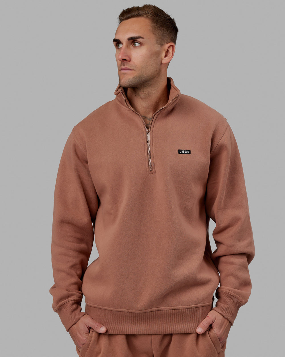 Man wearing Unisex Fundamental 1/4 Zip Sweater - Raw Umber