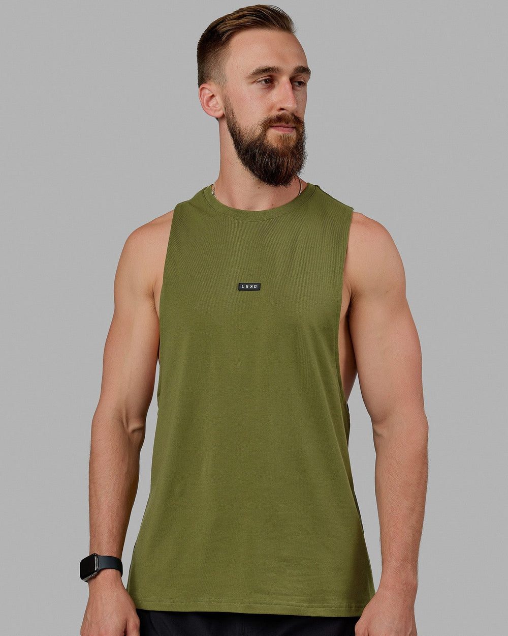 Man wearing Fundamental FLXCotton Drop Arm Tank - Moss