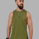 Man wearing Fundamental FLXCotton Drop Arm Tank - Moss
