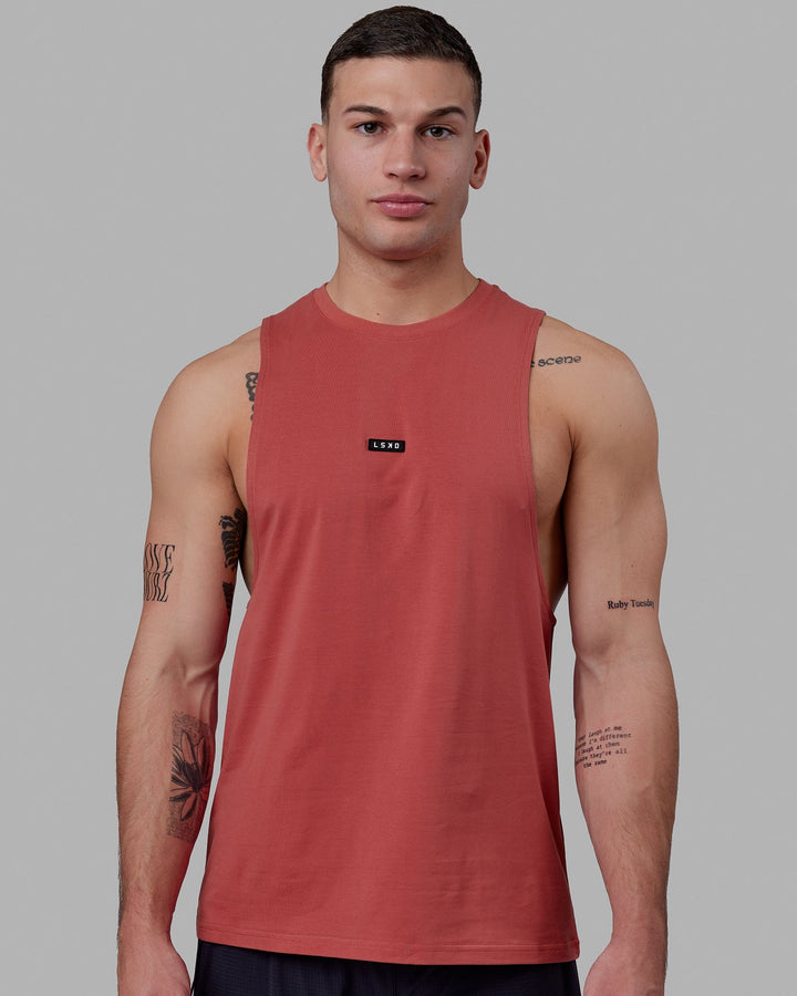 Man wearing Fundamental FLXCotton Drop Arm Tank - Mineral Red