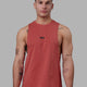 Man wearing Fundamental FLXCotton Drop Arm Tank - Mineral Red
