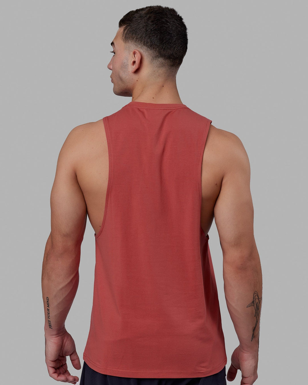 Man wearing Fundamental FLXCotton Drop Arm Tank - Mineral Red