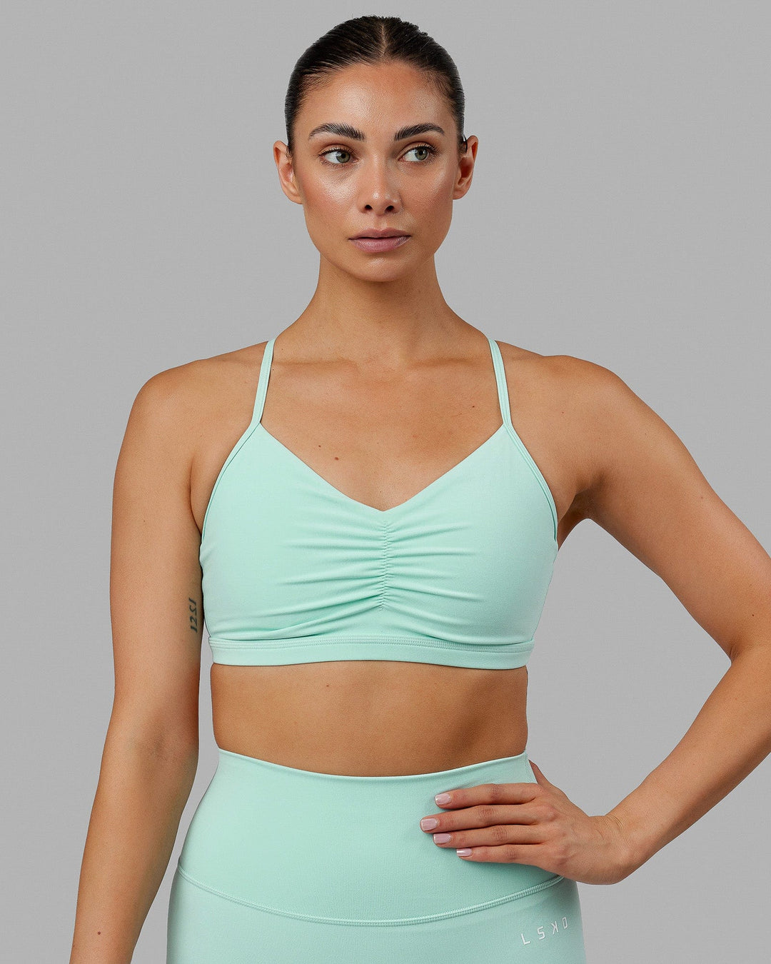 Woman wearing Fundamental Sports Bra - Pastel Turquoise