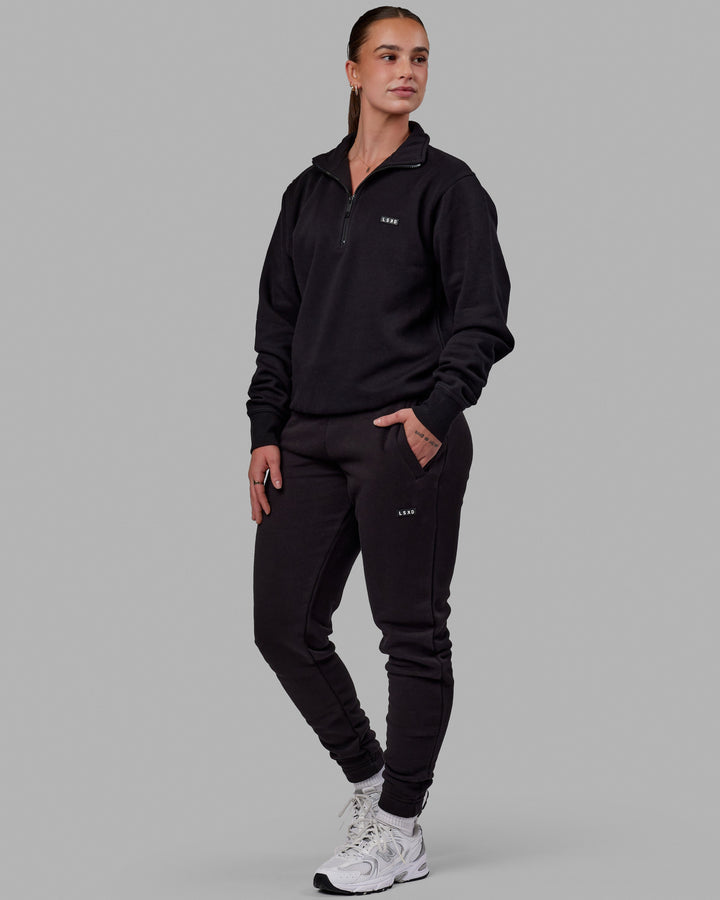 Woman wearing Unisex Fundamental Track Pant - Black