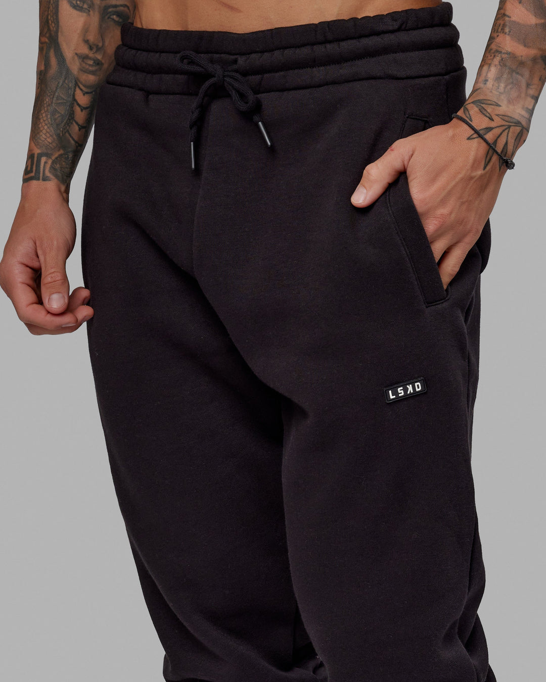 Man wearing Unisex Fundamental Track Pant - Black