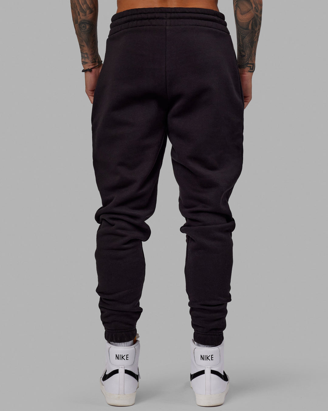 Man wearing Unisex Fundamental Track Pant - Black