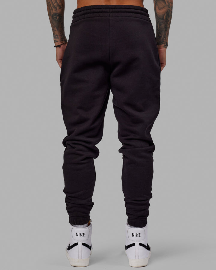 Man wearing Unisex Fundamental Track Pant - Black