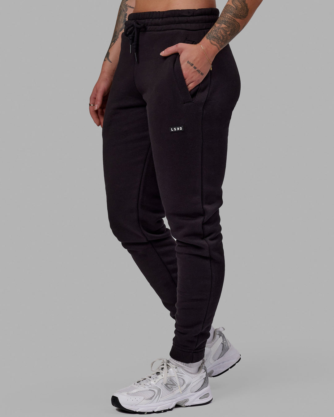 Woman wearing Unisex Fundamental Track Pant - Black