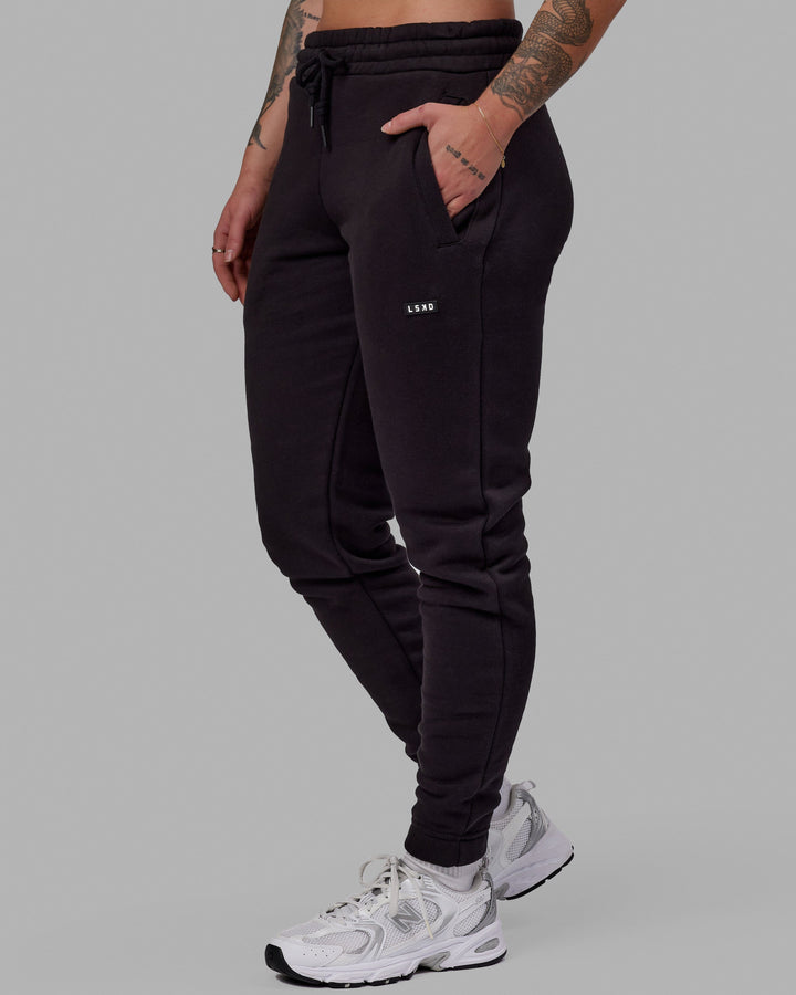 Woman wearing Unisex Fundamental Track Pant - Black