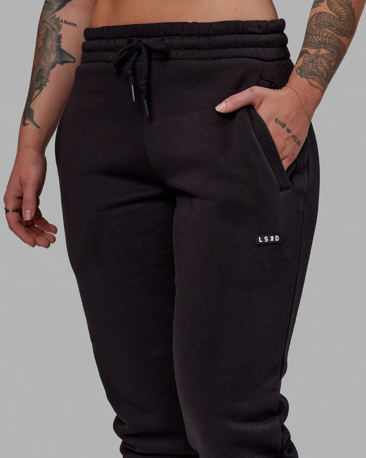 Woman wearing Unisex Fundamental Track Pant - Black