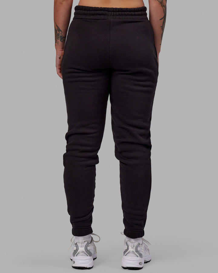 Woman wearing Unisex Fundamental Track Pant - Black