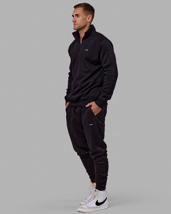 Man wearing Unisex Fundamental Track Pant - Black