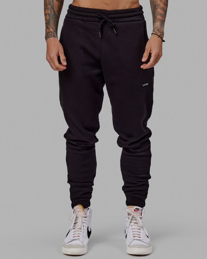 Man wearing Unisex Fundamental Track Pant - Black