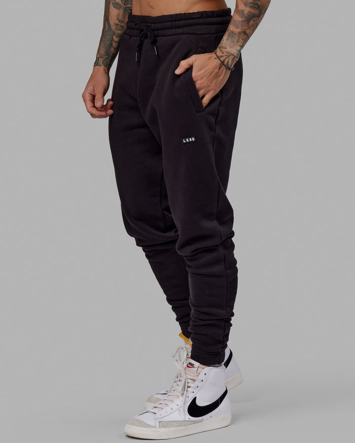 Man wearing Unisex Fundamental Track Pant - Black