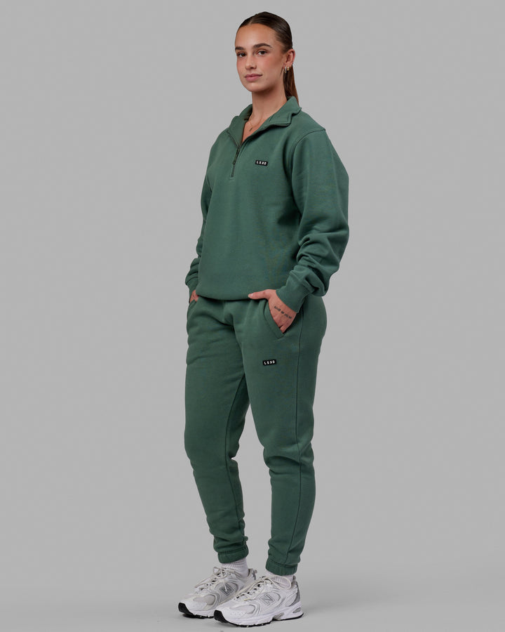 Woman wearing Unisex Fundamental Track Pant - Dark Forest
