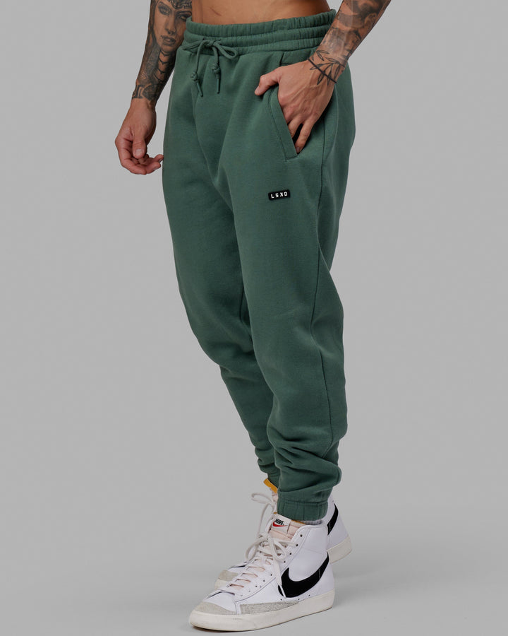 Man wearing Unisex Fundamental Track Pant - Dark Forest