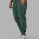Man wearing Unisex Fundamental Track Pant - Dark Forest