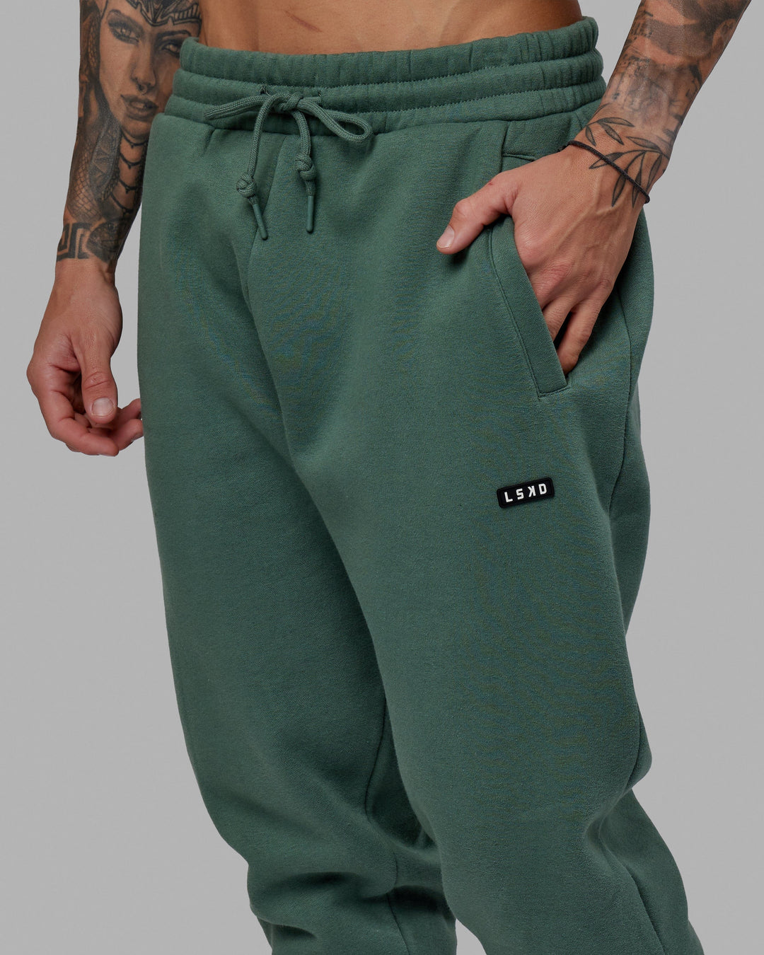 Man wearing Unisex Fundamental Track Pant - Dark Forest
