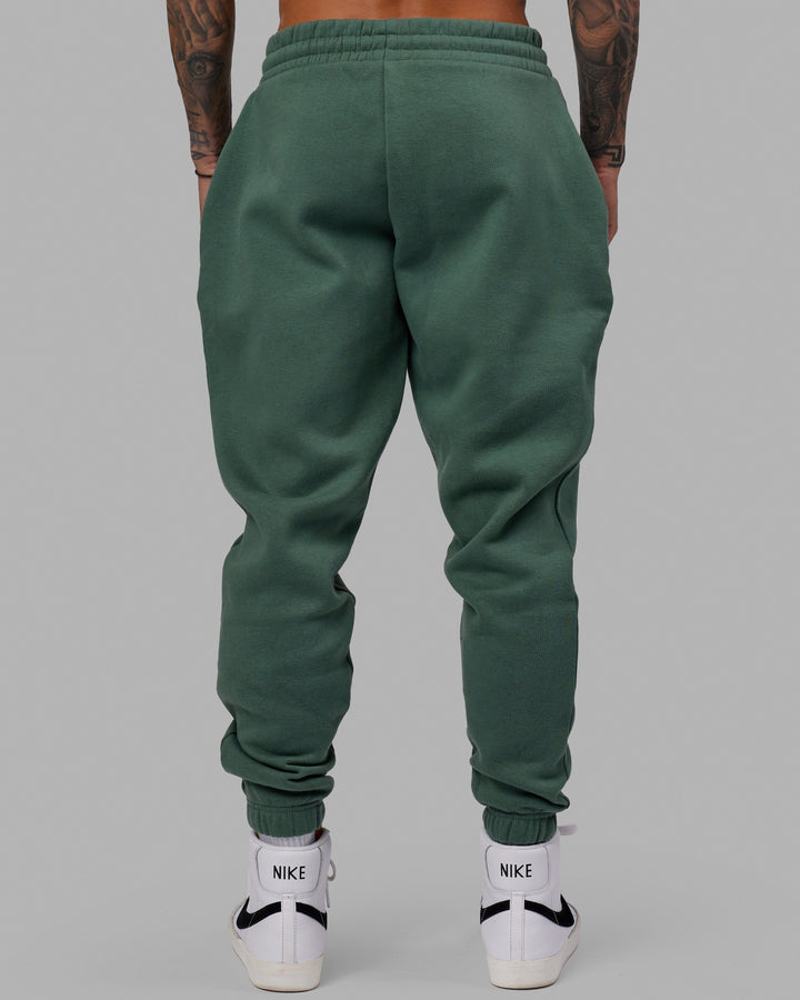 Man wearing Unisex Fundamental Track Pant - Dark Forest