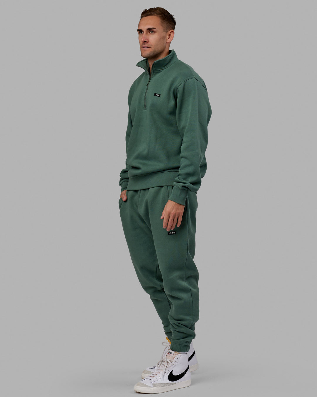 Man wearing Unisex Fundamental Track Pant - Dark Forest