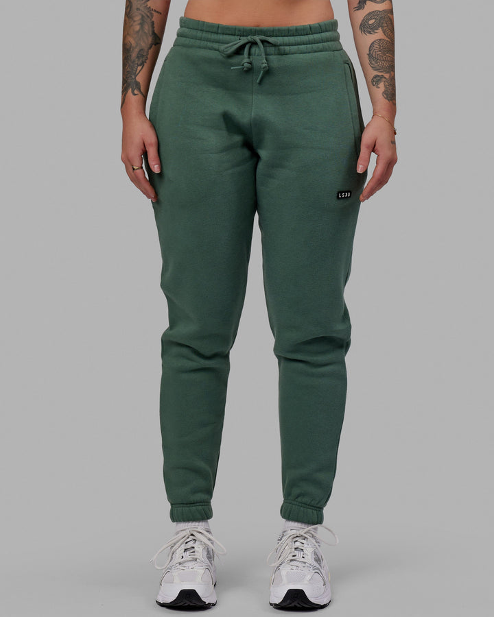 Woman wearing Unisex Fundamental Track Pant - Dark Forest