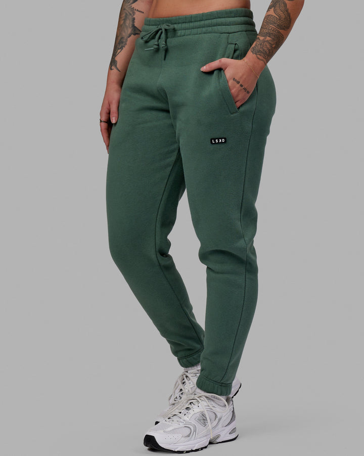 Woman wearing Unisex Fundamental Track Pant - Dark Forest