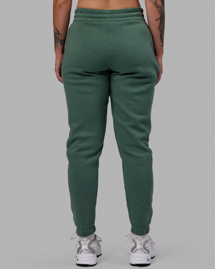 Woman wearing Unisex Fundamental Track Pant - Dark Forest