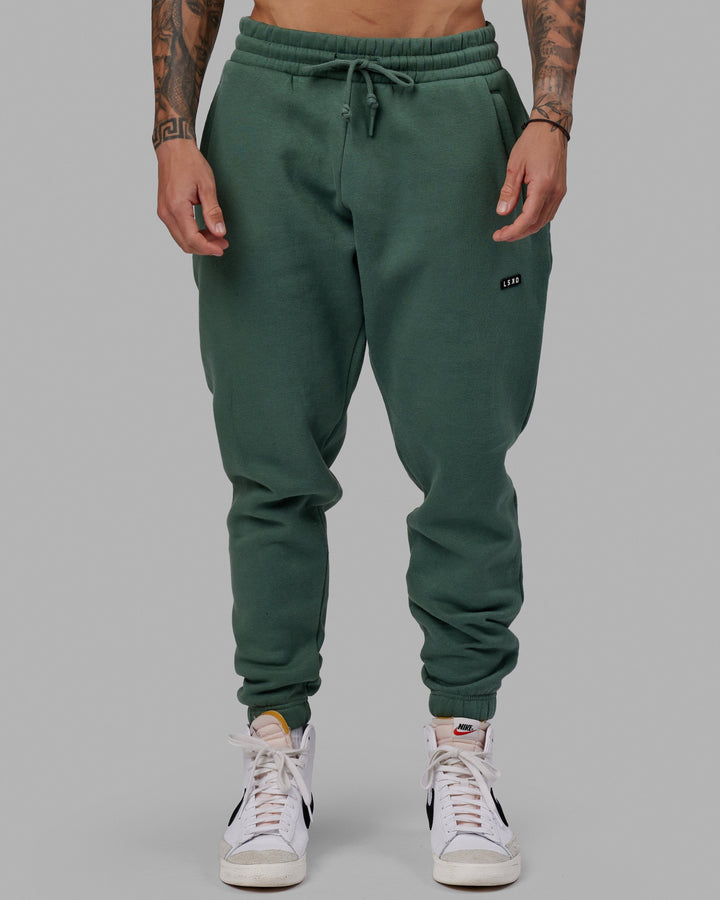 Man wearing Unisex Fundamental Track Pant - Dark Forest