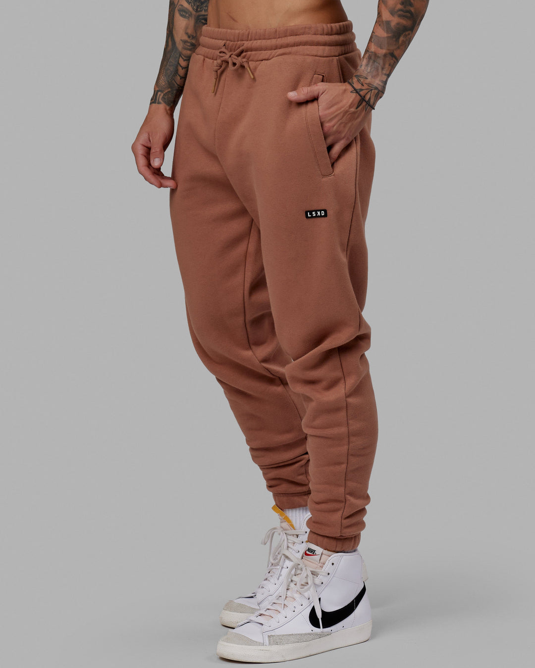 Man wearing Unisex Fundamental Track Pant - Raw Umber