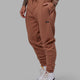Man wearing Unisex Fundamental Track Pant - Raw Umber