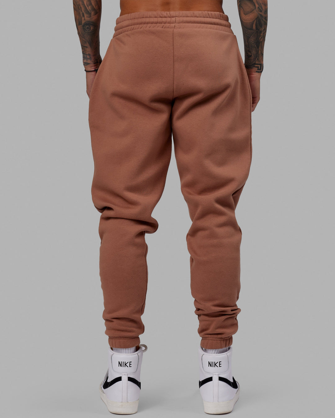 Man wearing Unisex Fundamental Track Pant - Raw Umber