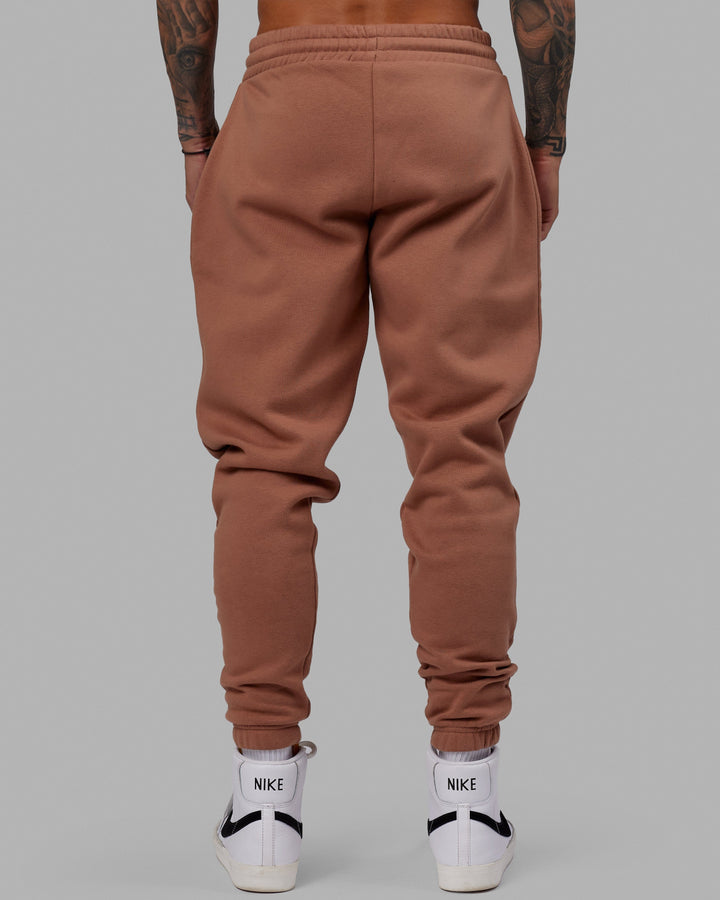 Man wearing Unisex Fundamental Track Pant - Raw Umber