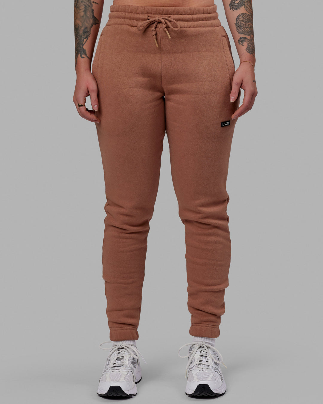 Woman wearing Unisex Fundamental Track Pant - Raw Umber