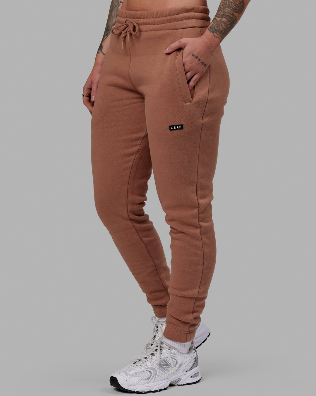Woman wearing Unisex Fundamental Track Pant - Raw Umber