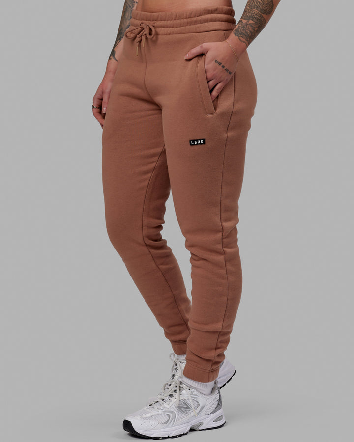Woman wearing Unisex Fundamental Track Pant - Raw Umber