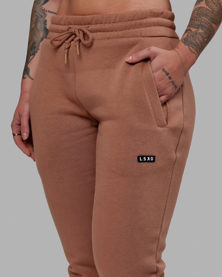 Woman wearing Unisex Fundamental Track Pant - Raw Umber