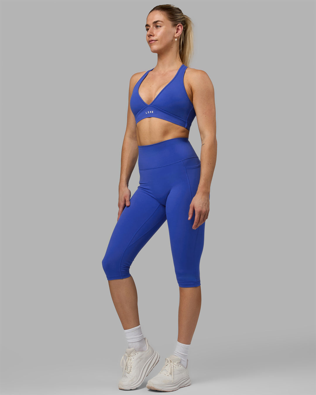 Woman wearing Fusion Ultra High-Rise 3/4 Legging Pockets - Power Cobalt | Model:Hannah | Size:S