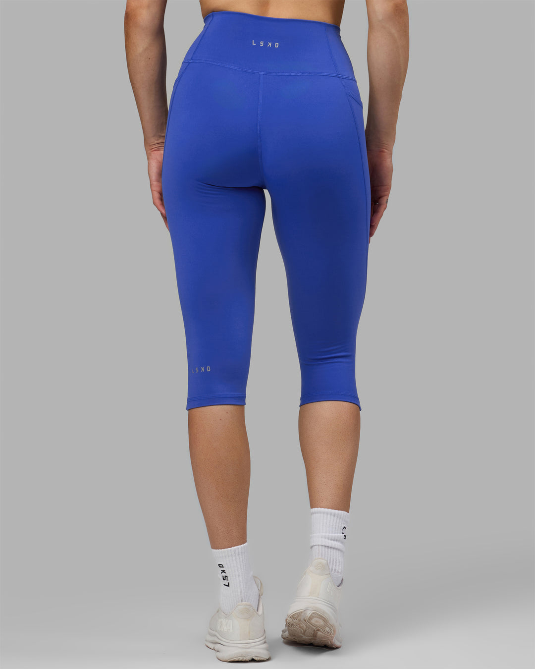 Woman wearing Fusion Ultra High-Rise 3/4 Legging Pockets - Power Cobalt | Model:Hannah | Size:S