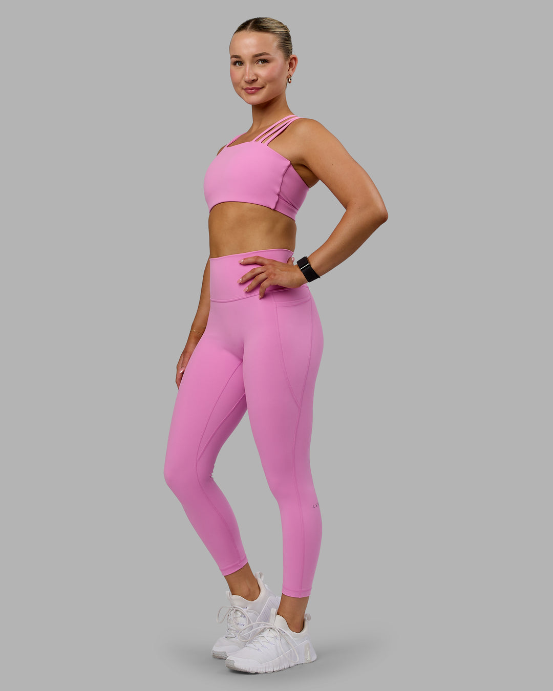 Woman wearing Fusion Ultra High-Rise 7/8 Legging Pockets - Spark Pink | Model:Halle | Size:S
