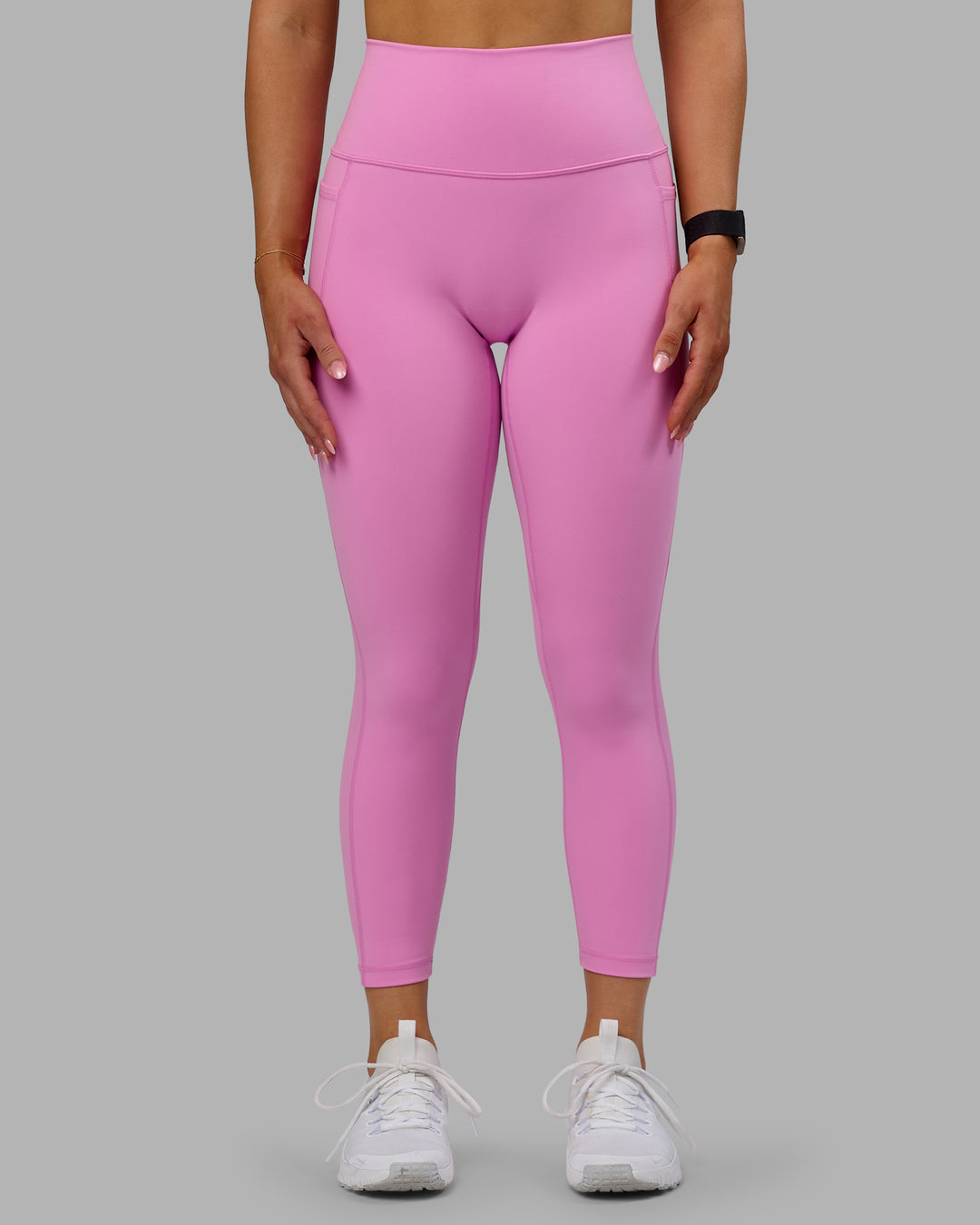 Woman wearing Fusion Ultra High-Rise 7/8 Legging Pockets - Spark Pink | Model:Halle | Size:S
