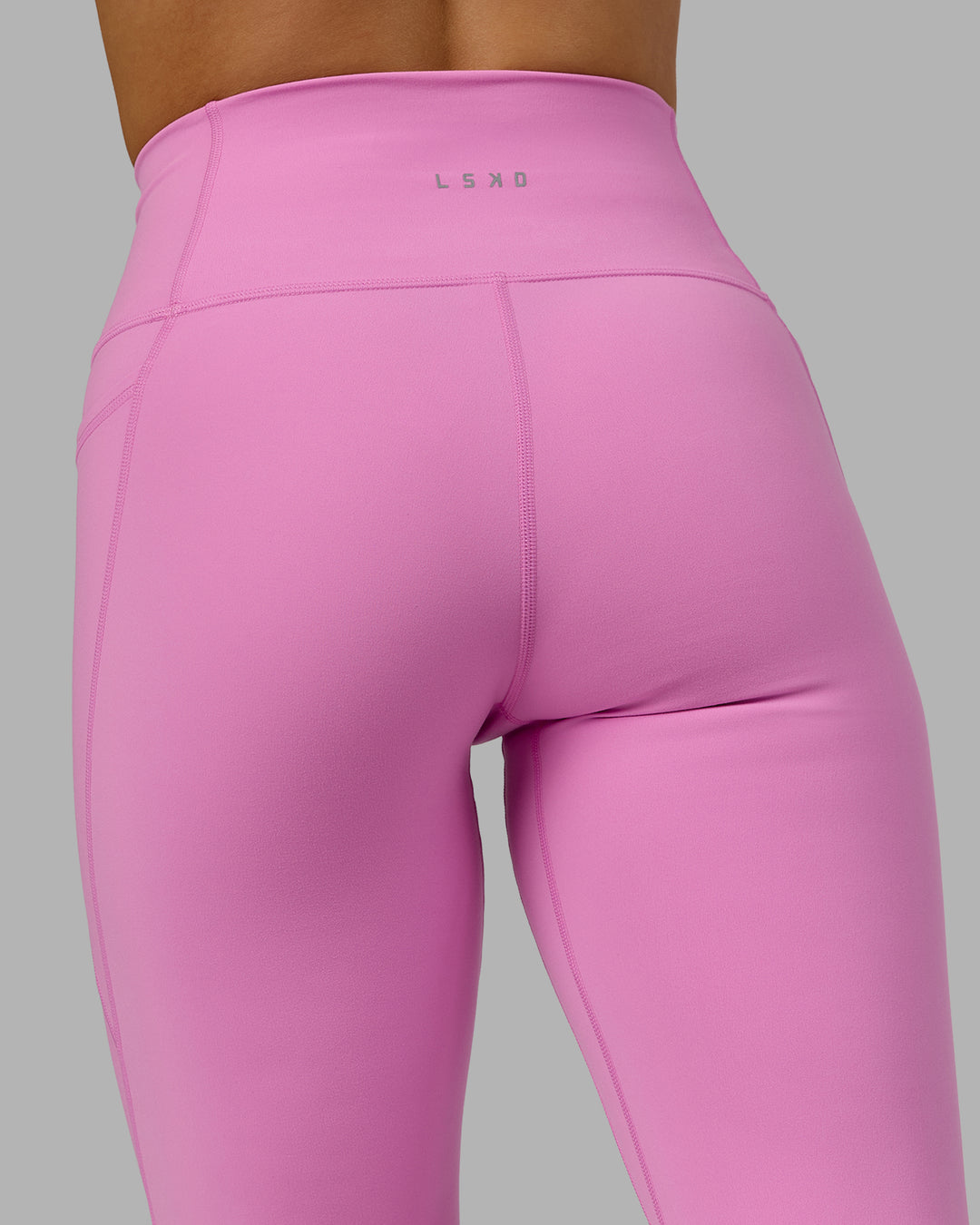 Woman wearing Fusion Ultra High-Rise 7/8 Legging Pockets - Spark Pink | Model:Halle | Size:S