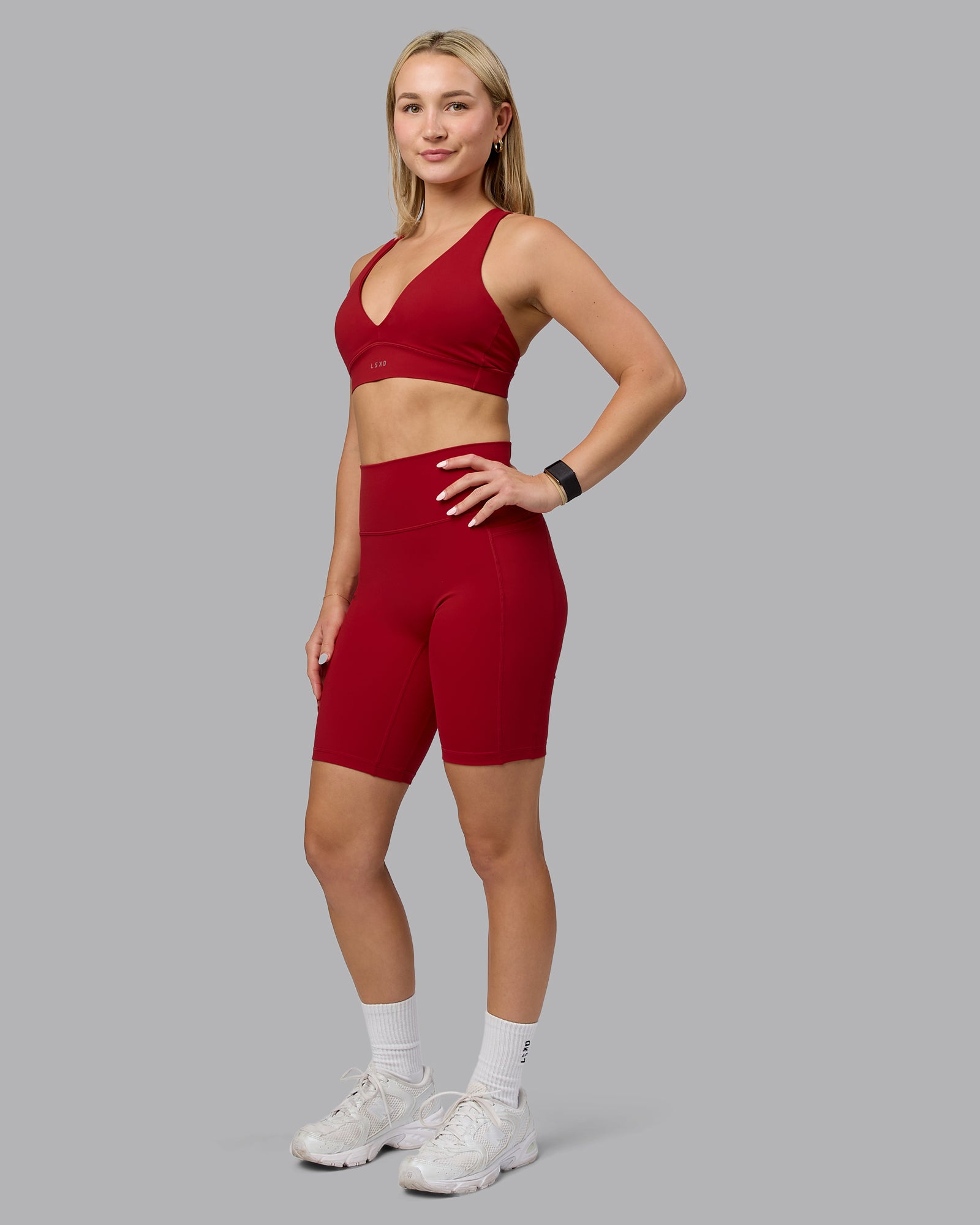 Woman wearing Fusion Ultra High-Rise 9" Short Pockets - Cherry Red | Model:Halle | Size:S