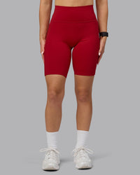 Woman wearing Fusion Ultra High-Rise 9" Short Pockets - Cherry Red | Model:Halle | Size:S