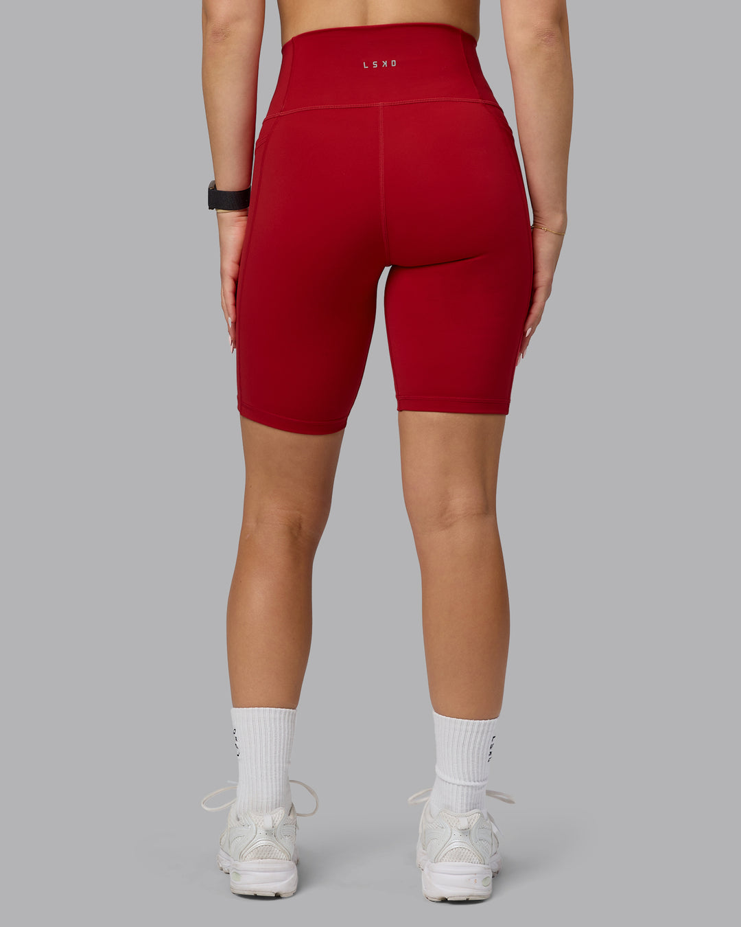 Woman wearing Fusion Ultra High-Rise 9&quot; Short Pockets - Cherry Red | Model:Halle | Size:S