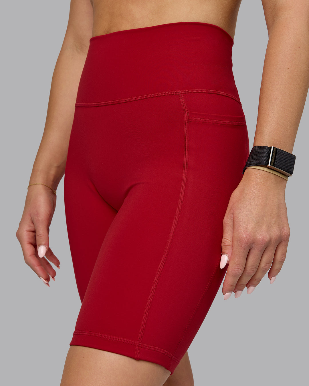 Woman wearing Fusion Ultra High-Rise 9&quot; Short Pockets - Cherry Red | Model:Halle | Size:S