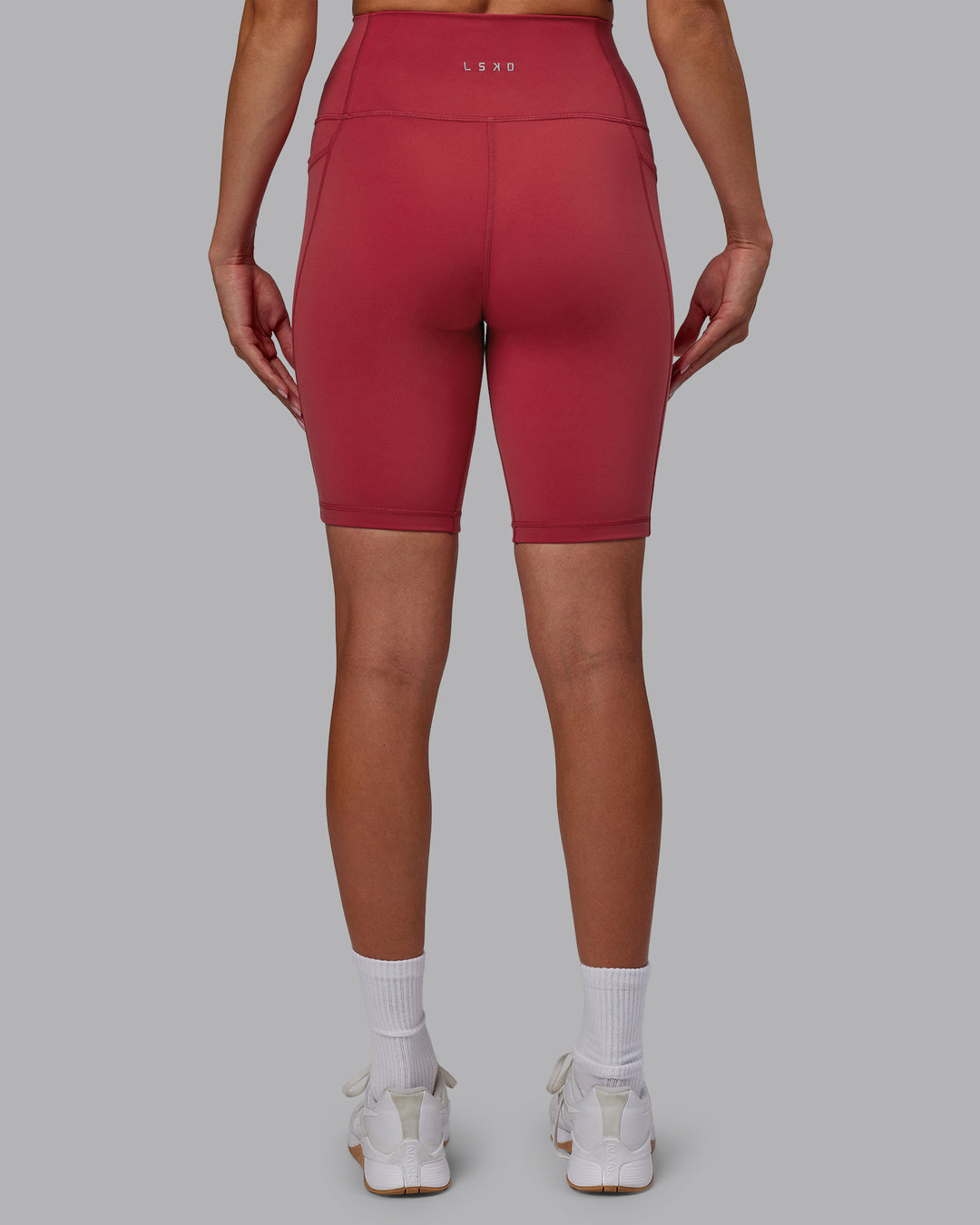 Woman wearing Fusion Ultra High-Rise 9" Short Pockets - Claret | Model:Blaize | Size:S