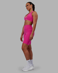 Woman wearing Fusion Ultra High-Rise 9" Short Pockets - Fuchsia Pink | Model:Sophie | Size:S