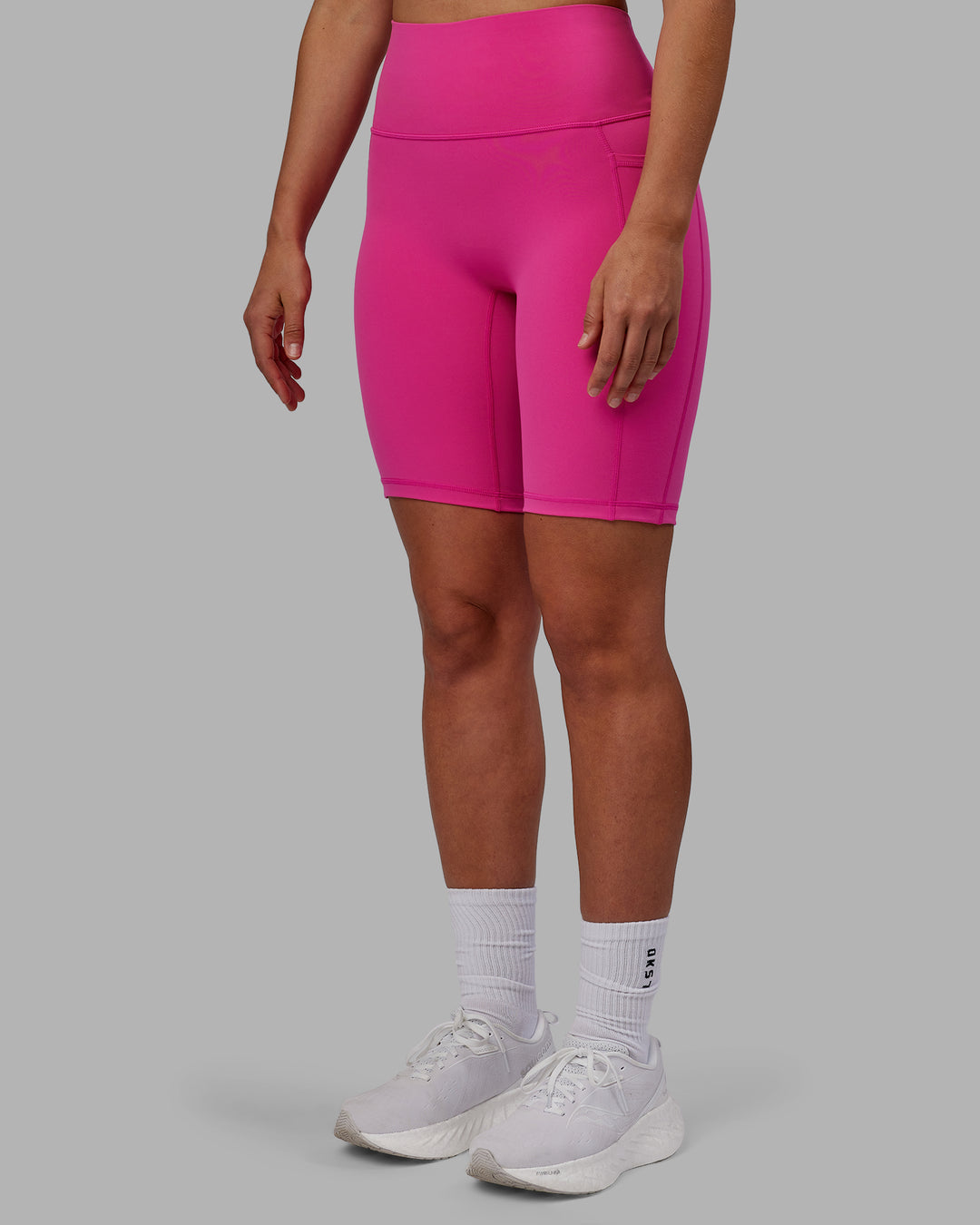 Woman wearing Fusion Ultra High-Rise 9" Short Pockets - Fuchsia Pink | Model:Sophie | Size:S