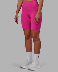 Woman wearing Fusion Ultra High-Rise 9" Short Pockets - Fuchsia Pink | Model:Sophie | Size:S