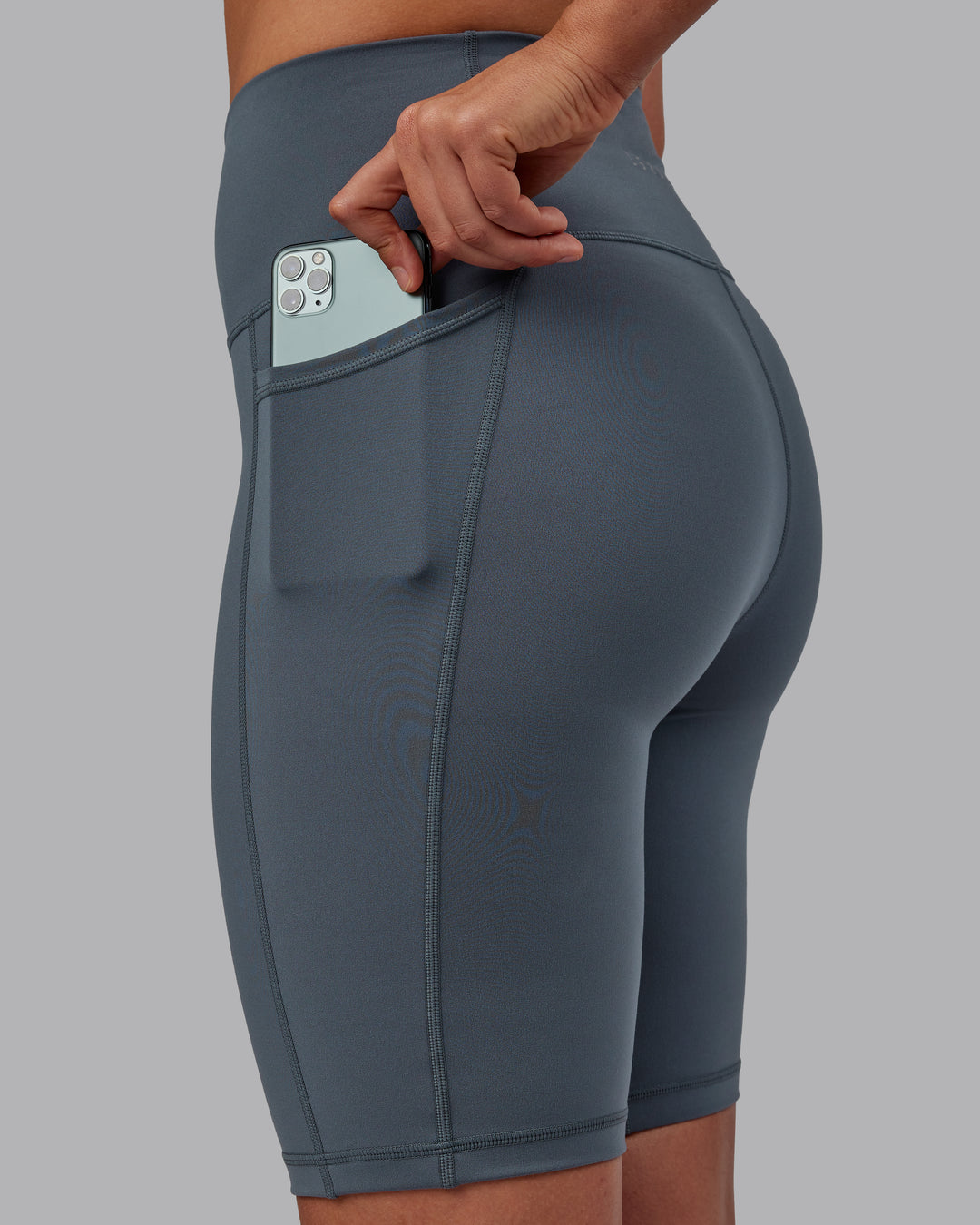 Woman wearing Fusion Ultra High-Rise 9&quot; Short Pockets - Turbulence | Model:Sophie | Size:S